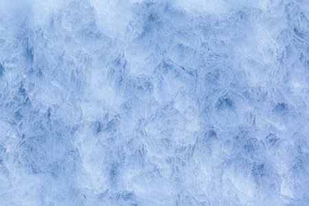 Texture of winter ice on a stone cliff. Blue natural ice background.の写真素材