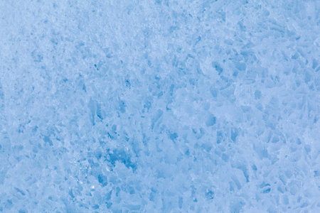 Texture of winter ice surface in the form of polygonal patterns. Blue natural ice background.の写真素材