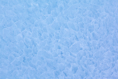Texture of winter ice surface in the form of polygonal patterns. Blue natural ice background.の写真素材