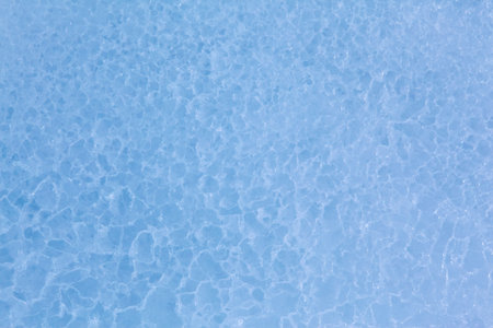 Texture of winter ice surface in the form of polygonal patterns. Blue natural ice background.の写真素材