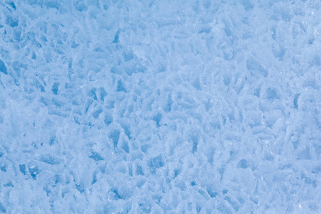 Texture of winter ice surface in the form of polygonal patterns. Blue natural ice background.の写真素材