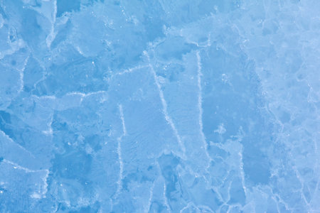 Texture of winter ice surface in the form of polygonal patterns. Blue natural ice background.の写真素材