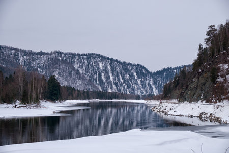 Altai river Biya in winter season. Banks of river are covered by ice and snow. Altai, Siberia, Russiaの写真素材