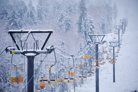 Teletsky Altai winter mountain ski resort near Iogach. Elevator on mount and forest background under snowfall.の写真素材