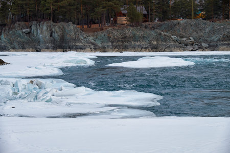 Rapids of Altai river Katun with banks covered by ice and snow in winter season near Elekmonar settlement, Siberia, Russiaの写真素材