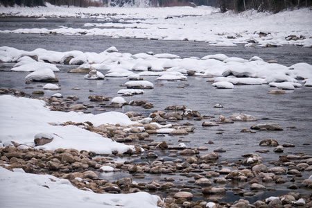 Stones with snow caps in the water of Altai Biya river in winter season. Altai, Siberia Russiaの写真素材