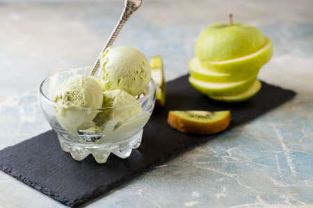 Green refreshing pistachio ice cream in glass bowl, selective focusの写真素材