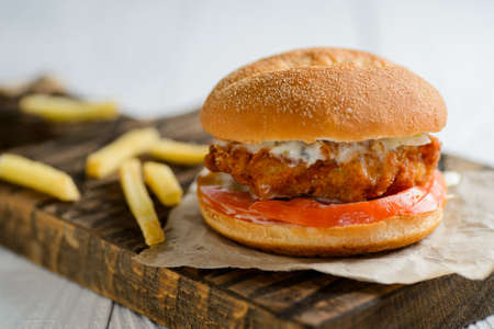 Fresh tasty chicken burger on wooden tableの写真素材