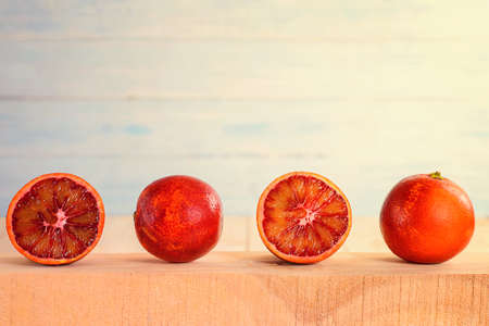 Red oranges on a wooden surfaceの写真素材