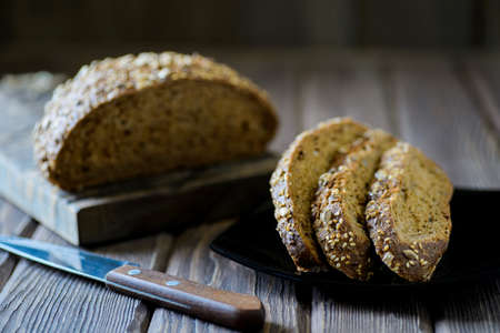 freshly baked multigrain bread on rustic backgroundの写真素材