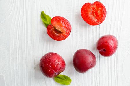fresh juicy plums with drops on a white background, top viewの写真素材