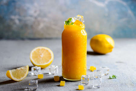 The cooled orange jam with pieces of a lemon and mintの写真素材
