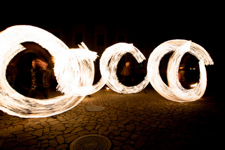 Fiery streaks during the fireshow at the nightの写真素材