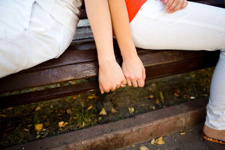 Attractive couple hugging in the park, close up.