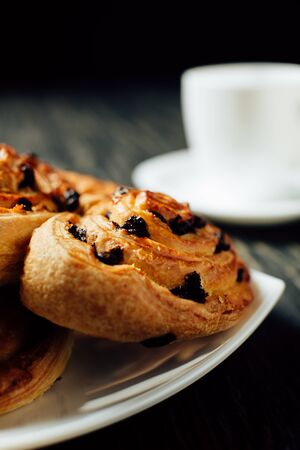 Delicious homemade bakery with chocolate on dark wooden table.の写真素材