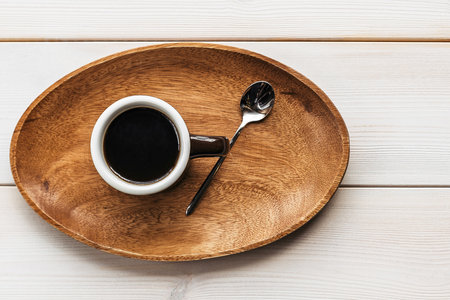 Coffee with milk americano espresso on a wooden background and a tray in a cup. Coffee americano espresso wooden cup.の写真素材