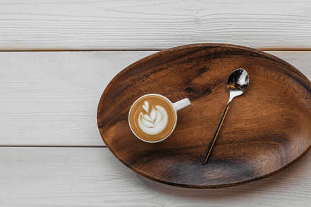 Coffee with milk americano espresso on a wooden background and a tray in a cup. Coffee americano espresso wooden cup.の写真素材