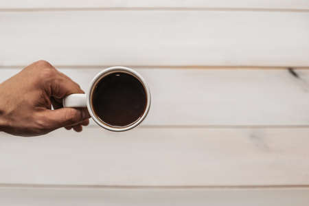 Americano coffee brewing in a teapot a cup. Coffee in cup on wooden.の写真素材