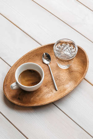 Americano coffee brewing in a teapot a cup. Coffee in cup on wooden.の写真素材
