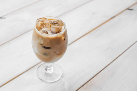 Coffee cappuccino latte in cup on wooden table. Cappuccino coffee latte on a wooden table in a cup.