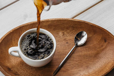 V60 funnel coffee, freshly brewed coffee. Coffee V60 with cup on wooden table.の写真素材