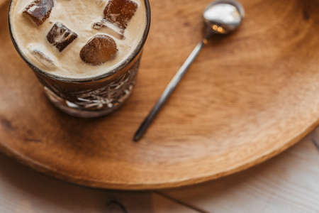 Espresso tonic coffee. Espresso coffee tonic in a glass cup on a blackboard with a spoon.