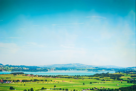landscape with lakes, fields and blue sky in germanyの写真素材
