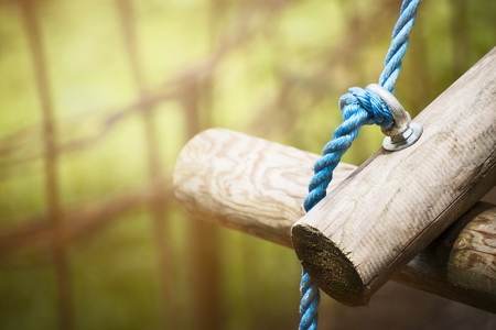 logs on rope bridge in climbing forest or high wire park on nature sunny background, close upの写真素材