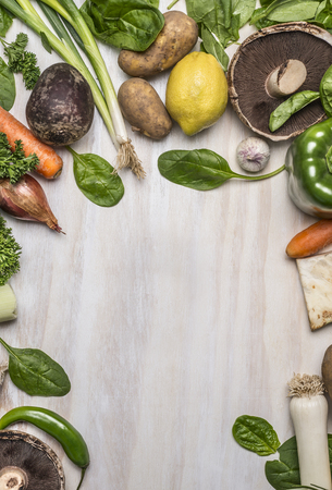 frame of fresh vegetables, fruits,mushrooms and herbs on wooden rustic background top view close upの写真素材