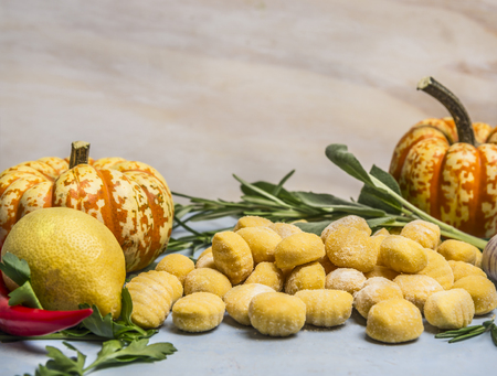 pumpkin gnocchi with pumpkin pepper lemon herbs  on blue wooden background close upの写真素材