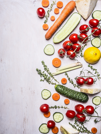 border Vegetarian food tomatoes on a branch carrot cucumber lemon herbs place for text on wooden rustic background top viewの写真素材