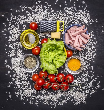 Ingredients for risotto with ham, vegetables and spices on wooden rustic background top view close upの写真素材