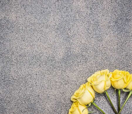 beautiful yellow rose bouquet in a rustic granite background, top view place for textの写真素材