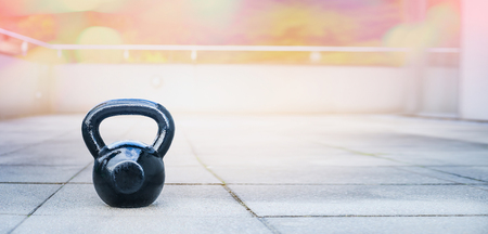 the kettlebell for outdoor sports, stands on the terrace of the houseの写真素材