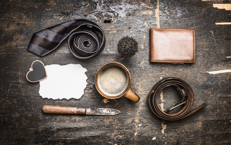 concept of father's day, a cup of coffee, tie, belt, knife, leather wallet, place for text on a postcardの写真素材