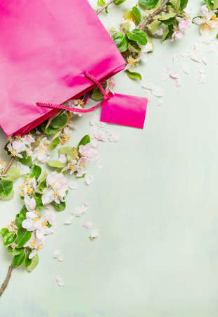 the season of sales in the shop, pink shopping bags beautiful summer flowers, space for textの写真素材