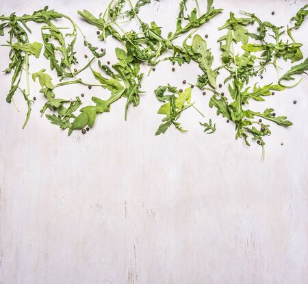Healthy foods, cooking and vegetarian concept  arugula salad on wooden rustic background top view close up place for textの写真素材