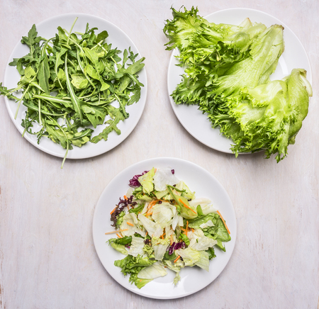 various types of lettuce, spread out on white plates, the concept of vegetarian cuisine Healthy foodの写真素材