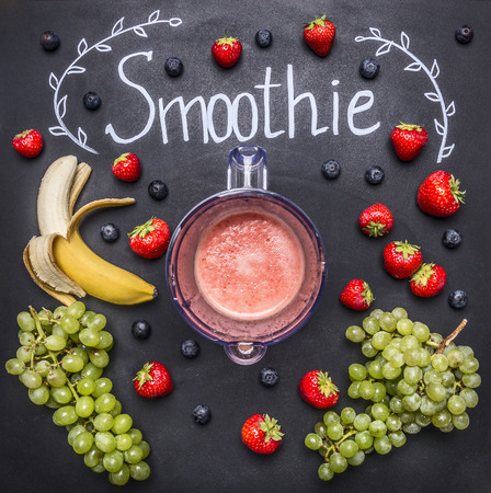 Smoothie ingredients, top view, border. Superfoods and health or detox diet food concept strawberries, bananas, white grapes, blueberriesの写真素材
