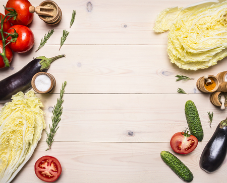 Healthy foods, cooking and vegetarian concept different vegetables and ingredients for the salad, laid out on a white wooden table, place for text, top viewの写真素材