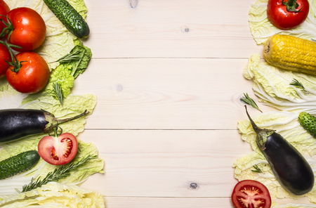Healthy lifestyle background with various colorful vegetables and herbs laid out in a frame on a white wooden table, space for text on wooden rustic background top view close upの写真素材