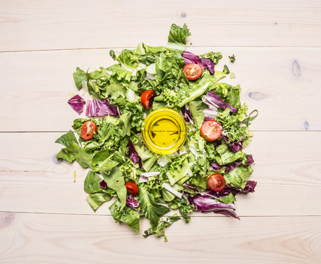 Ingredients for cooking vegetarian Salad with Cherry Tomatoes,olive oil on wooden rustic background top view close upの写真素材