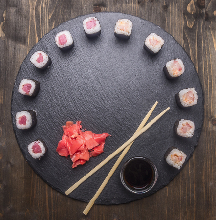 Japanese food, sushi with salmon and tuna, fresh ginger,  soy sauce and chopsticks lined up on a tray of chalk boards, frame, space for text, top viewの写真素材