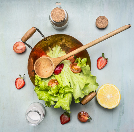 ingredients vegetarian salad with strawberry, cherry tomatoes, lemon and spices, healthy food, top viewの写真素材