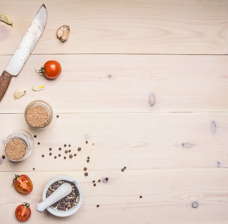Ingredients for cooking  spices, knife, salt and pepper shakers, cherry tomatoes on a white wooden rustic background, space for text, Borderの写真素材
