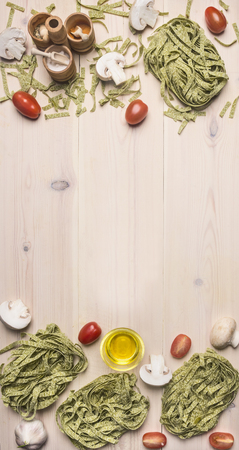 Ingredients for cooking vegetarian green pasta with cherry tomatoes, spices and Champignon, frame, space for textの写真素材
