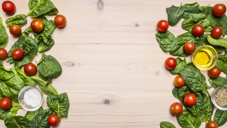 Healthy lifestyle background with various colorful vegetables and herbs laid out in a frame on a white wooden table, space for text on wooden rustic background top view close upの写真素材