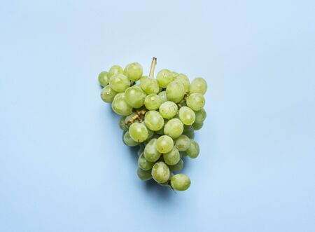 bunch of juicy ripe grapes on a blue background, top viewの写真素材