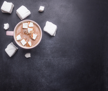 Cocoa in a pink cup with giant homemade marshmallow, on a chalkboard, space for textの写真素材