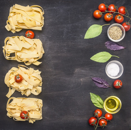 Healthy foods, cooking and vegetarian concept Raw Italian pasta with cherry tomatoes, mushrooms and butter, laid out on a rustic wooden background  border place for textの写真素材